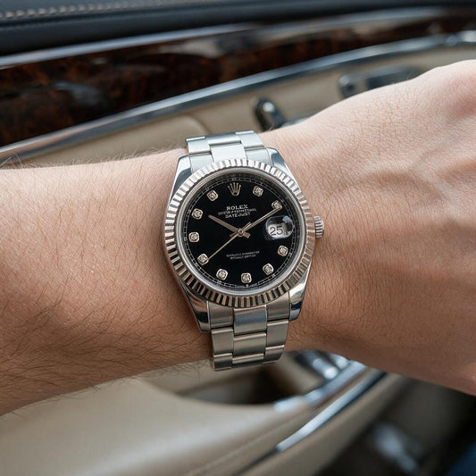 A Rolex Submariner Date watch with a black dial and silver Oyster bracelet, worn on a person's wrist inside a car.