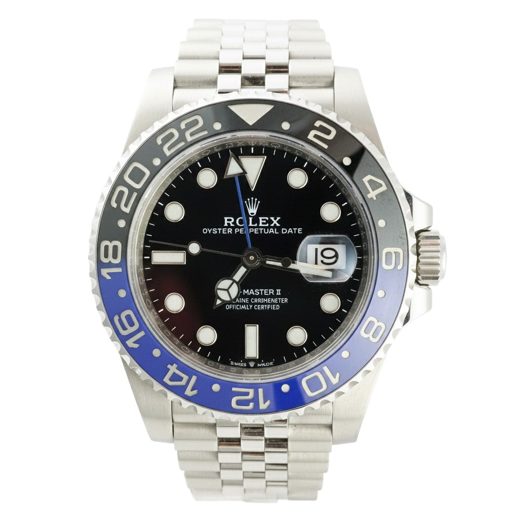 Rolex watch with black face and blue bezel on a white background