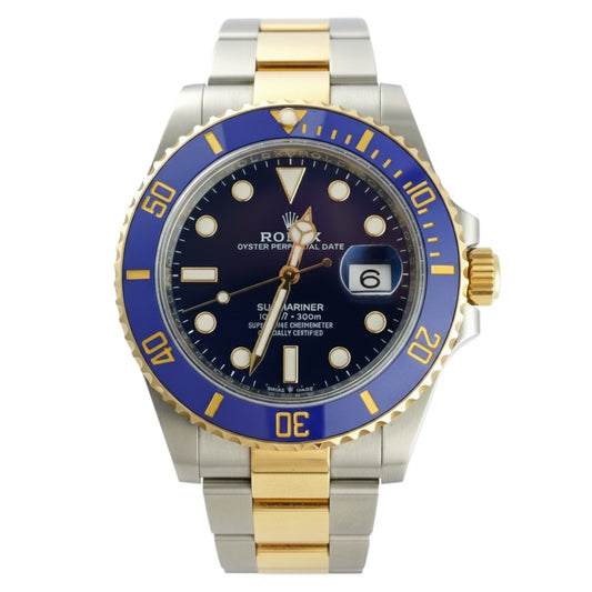 Luxury watch with blue and gold casing on a white background