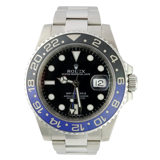 Rolex watch with black face and blue bezel on a white background