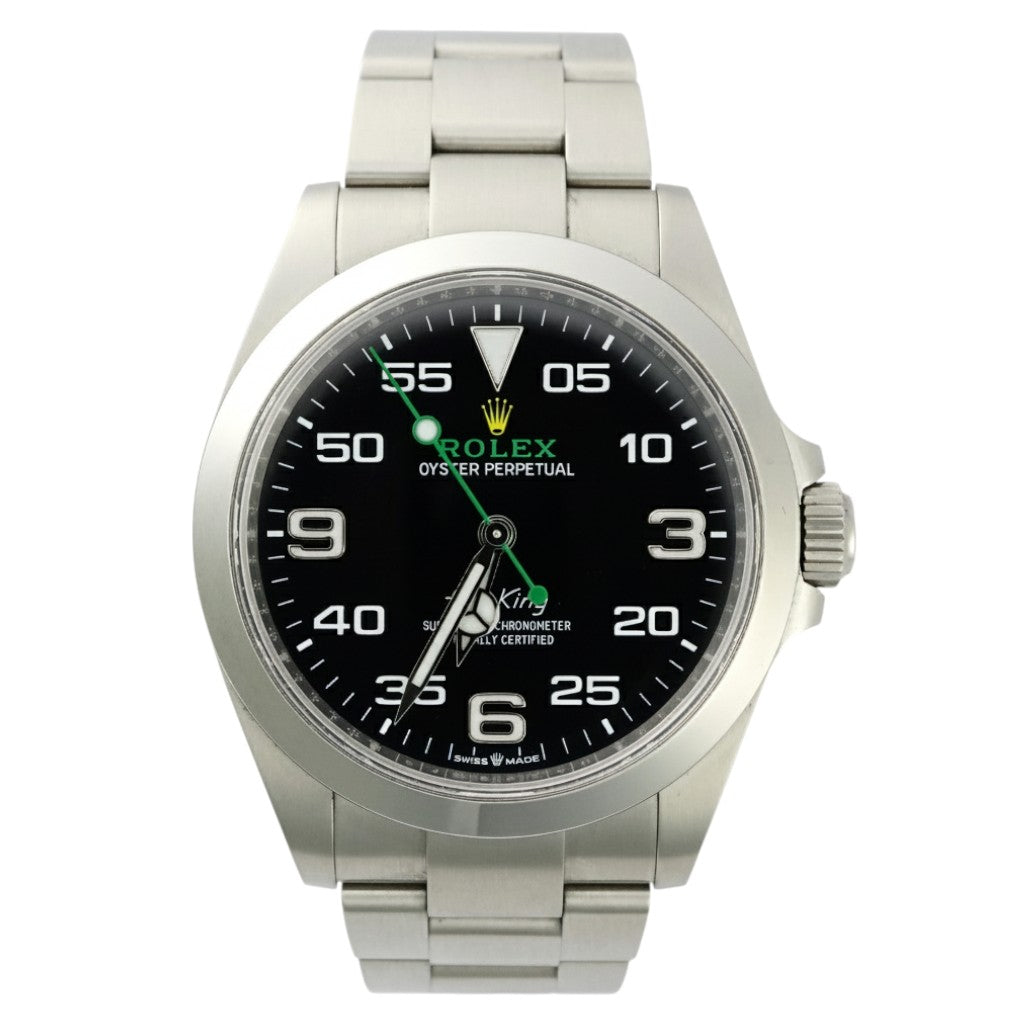 Silver Rolex watch with black dial on a white background